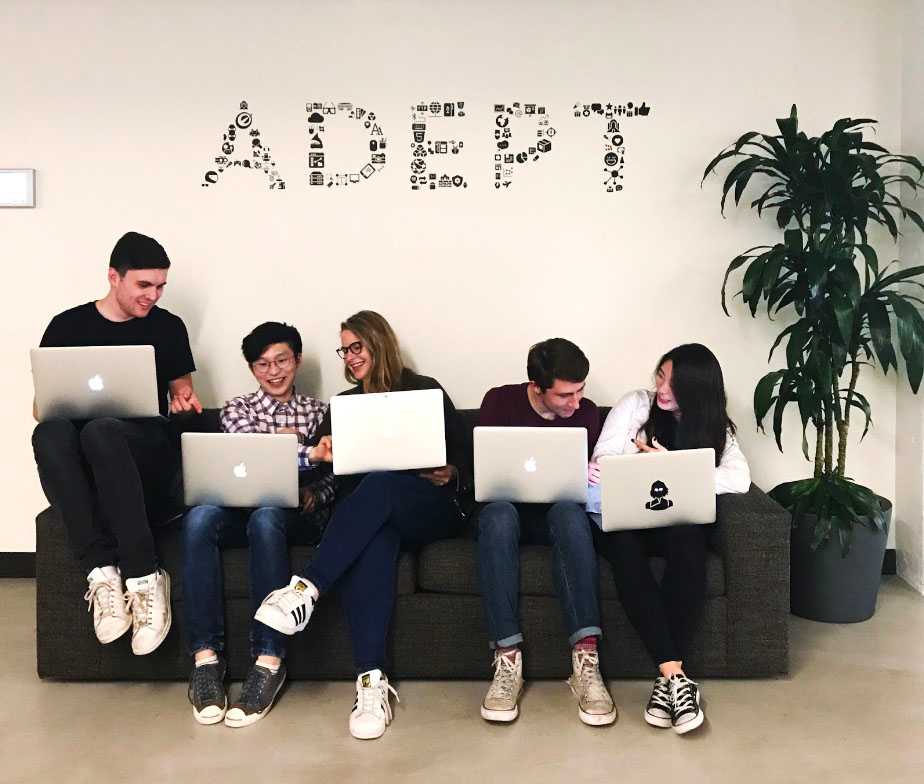 The 2017 Optimizely interns Zach, Angus, Caitlin, Derek, and Flora sitting on the intern couch in a candid manner